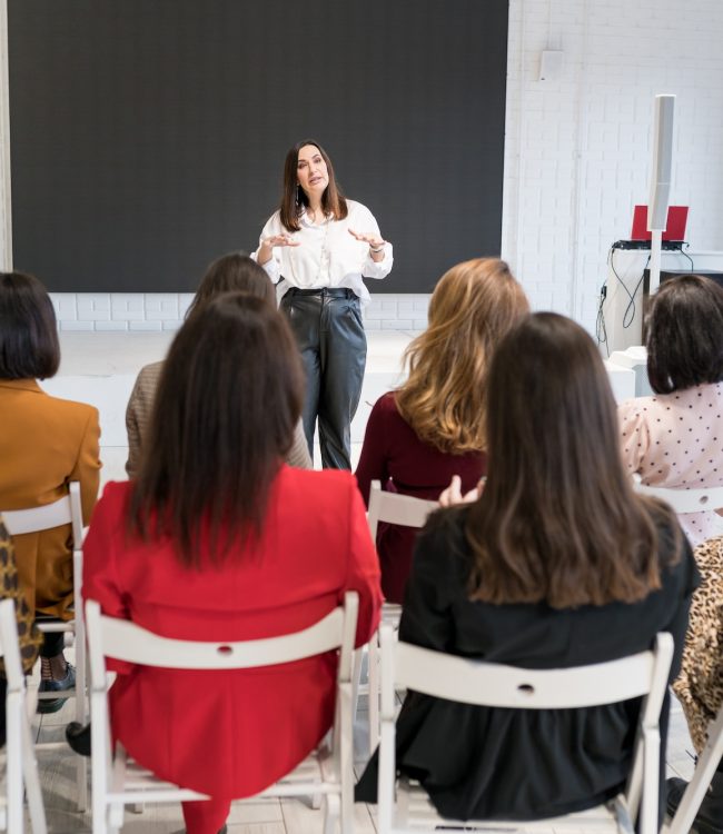 rear-view-of-unidentified-people-listening-to-coach-having-speech-at-business-training.jpg